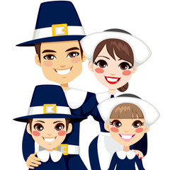 Family dressed with traditional pilgrim clothes for thanksgiving day