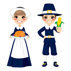 Two cute little children in pilgrim costume holding turkey and corn to celebrate Thanksgiving day