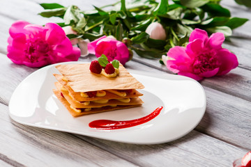 Dessert with red berries. Mint and custard. Sweet sauce for traditional millefeuille. Pastry from french cuisine.