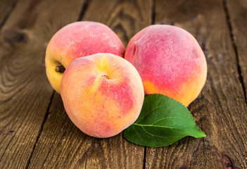 fresh peaches on wood background
