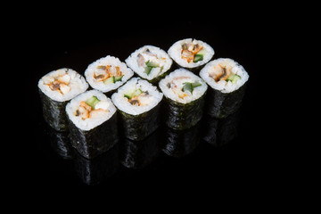 Japanese rolls on black background