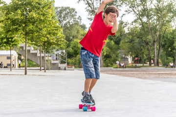 outdoor portrait of young smiling teenager boy riding short mode