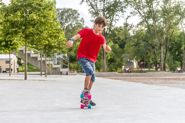 outdoor portrait of young smiling teenager boy riding short mode