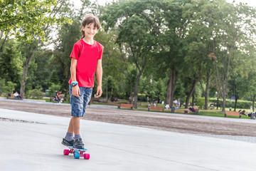 outdoor portrait of young smiling teenager boy riding short mode