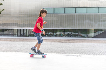 outdoor portrait of young smiling teenager boy riding short mode