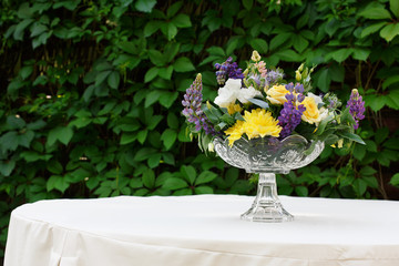 Beautiful flower bouquet outdoors. Wedding floristic decoration at white table