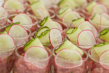 snack with radish and cucumber in a glass
