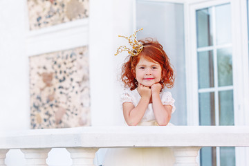 Sweet Princess girl with  red hair wearing Crown