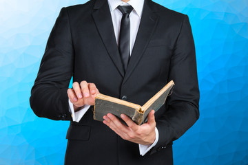 Unrecognizable businessman holding a book closeup