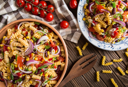 Mexican pasta salad with red bean, corn, tomato, onion and pepper