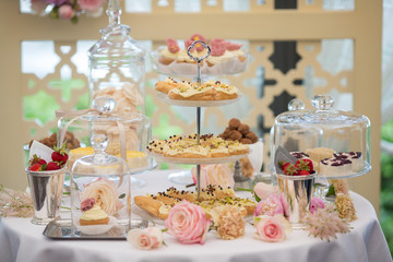 Dessert table for a party. Eclairs, cake, cupcakes, sweetness an
