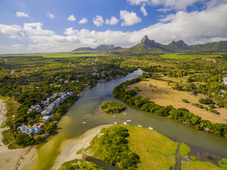 Top down aerial view of Black River Tamarin - Mauritius beach. Curepipe Black River Gorge National Park in background