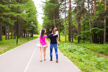 Fototapeta premium Happy young family spending time together outside in green nature.