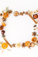 Obraz na płótnie Canvas dry flowers, cinnamon and cardamom round frame wreath pattern on white background. flat lay, top view