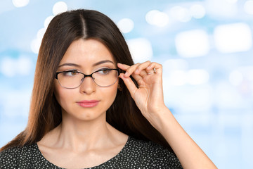 Portrait of happy smiling young business woman in glasses