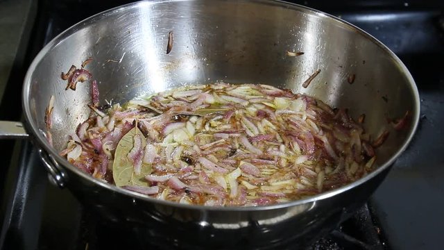 Chopped Onions cooking in Olive oil.