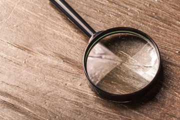 magnifying glass on the  wooden background