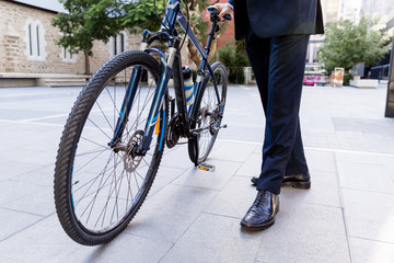 Naklejka premium Successful businessman riding bicycle