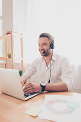 Portrait of young man in headphones working in call center
