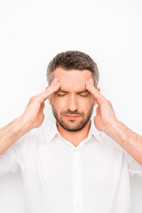 Portrait of sick unhappy businessman having strong headache