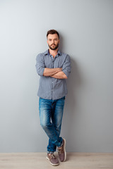 Full length portrait of  serious businessman with crossed hands