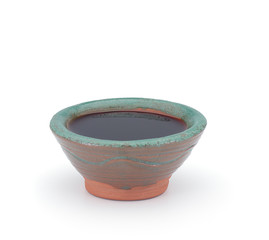 Soy sauce in a clay sauce-boat isolated on white background