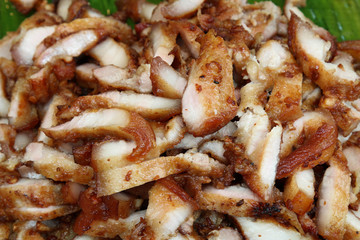 Thai style slice fried pork on banana leaf, thai street food