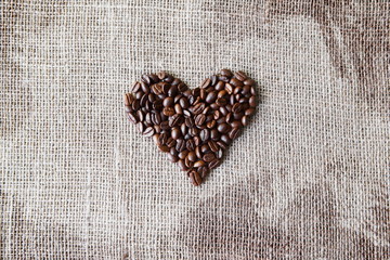 Burlap texture with coffee beans heart shape