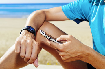 young sportsman syncing his smartwatch