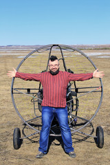 portrait of a man against the backdrop of a motor glider