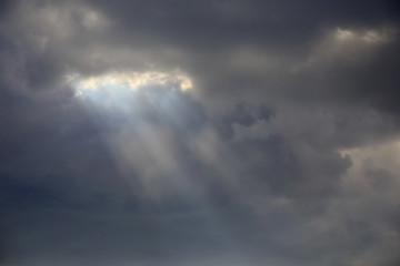 Fototapeta na wymiar rays through the clouds