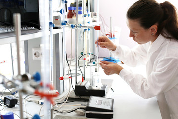 Girl chemist working in a chemical laboratory