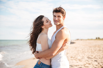 Couple standing and embracing on the beach