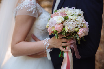 Wedding bouquet in marriage couple hands