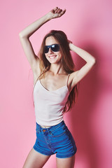 Naklejka premium Fashion portrait of blonde girl with sunglasses wearing pastel stylization