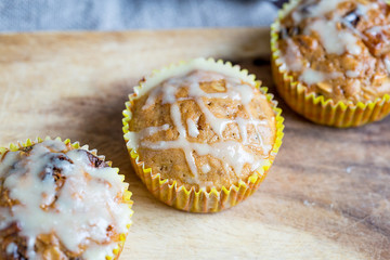 Healthy Oatmeal Muffins with Berries, Honey, Cinnamon and Melted White Chocolate Topping on Dark Wooden Rustic Background Horizontal View