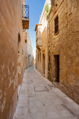 Fototapeta na wymiar Ancient narrow street in Mdina, old capital of Malta.