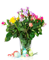 Easter eggs and flowers on wooden background