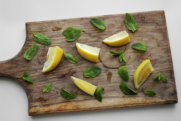 lemons and mint on a cutting board
