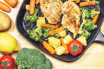 Lemon grilled chicken breast with fried vegetables in pan