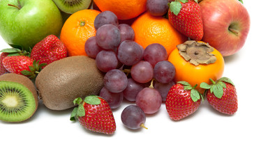 ripe strawberries and other fruits closeup on a white background