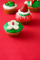Christmas cupcakes on red background

