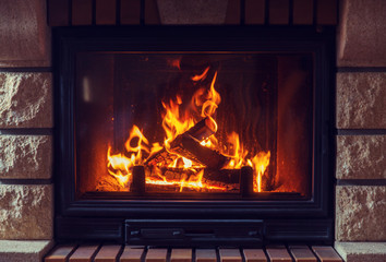 close up of burning fireplace at home - obrazy, fototapety, plakaty