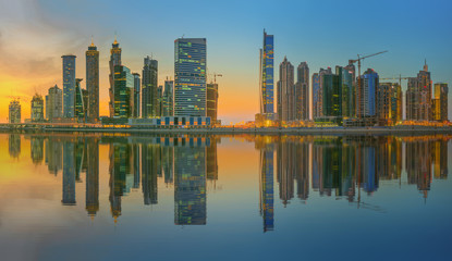 Fototapeta na wymiar Panoramic view of Business bay and downtown area of Dubai, reflection in a river, UAE