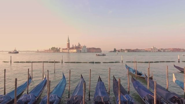 Drone aerial flying over parking gandolas with the bell tower of the Saint Giorgio Maggiore Church view.
