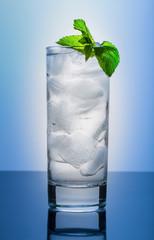 Cool glass of pure water on a blue background