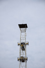 Loudspeakers broadcast tower on sky background.