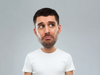 unhappy young man over gray background