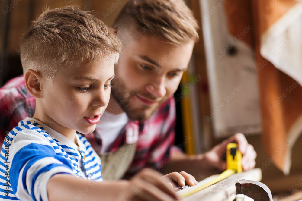 Wall mural father and son with ruler measure wood at workshop