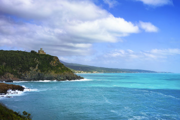 Cliff rock and building on the sea on sunset. Quercianella, Tusc